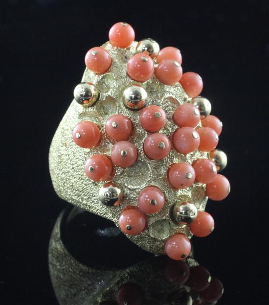 A large French textured 18ct gold and coral bead set cluster dress ring, size M.